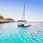 Sailing catamaran in a Mediterranean bay