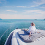 A woman enjoys a cruise on a luxury yacht