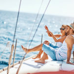 Young couple on a weekend getaway aboard a sailing yacht