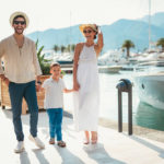 A family on holiday strolls along quai Saint-Pierre at the Old Port